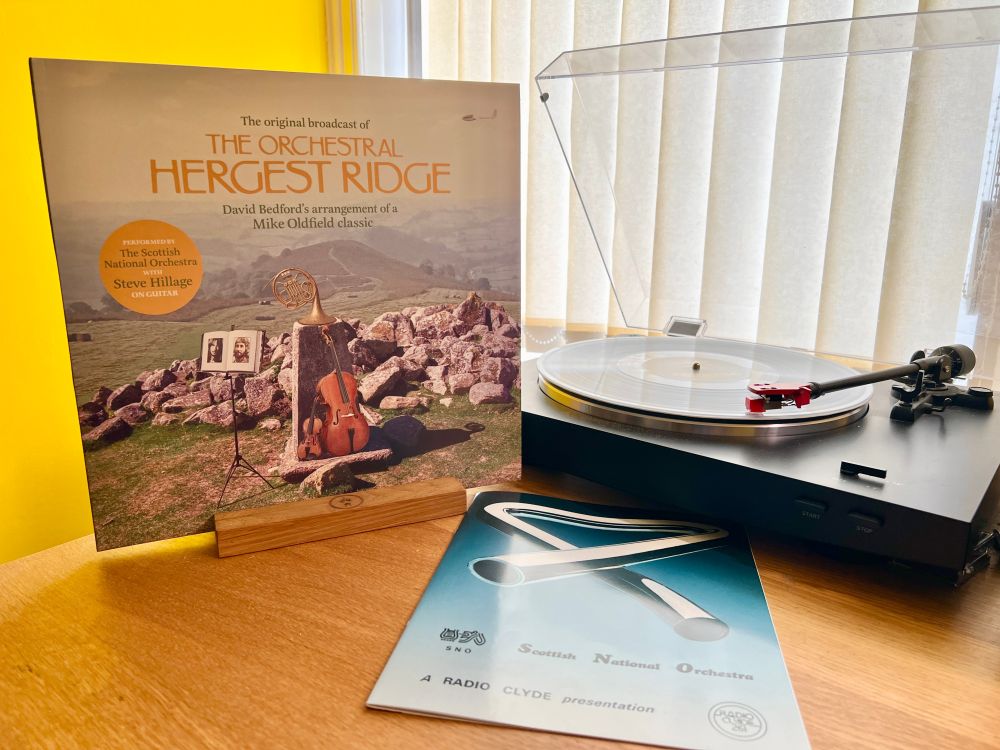 The cover of The Orchestral Hergest Ridge stands next to the turntable playing the LP