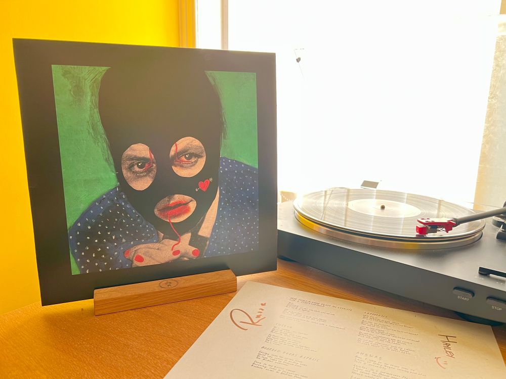 The cover of Here Comes A Man From The Council With A Flamethrower by A Formal Horse stands next to the turntable playing the LP