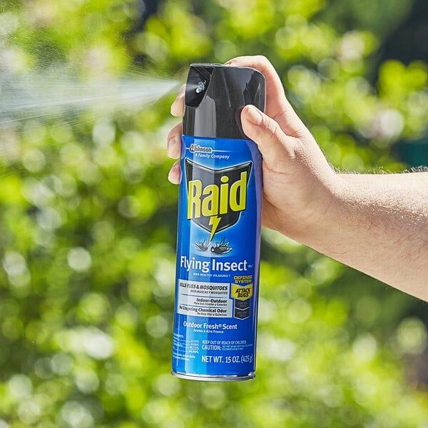 A raid bug spray being held and sprayed with impunity