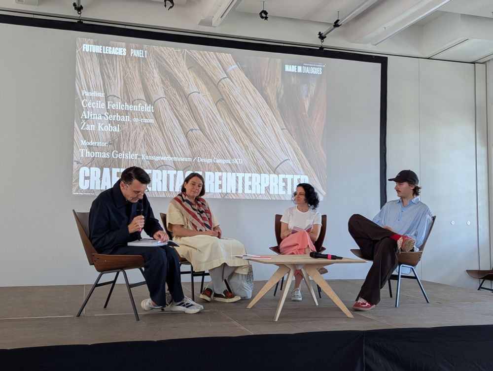 Four people sitting on the stage 