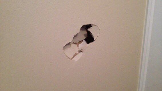 foot-shaped hole in drywall