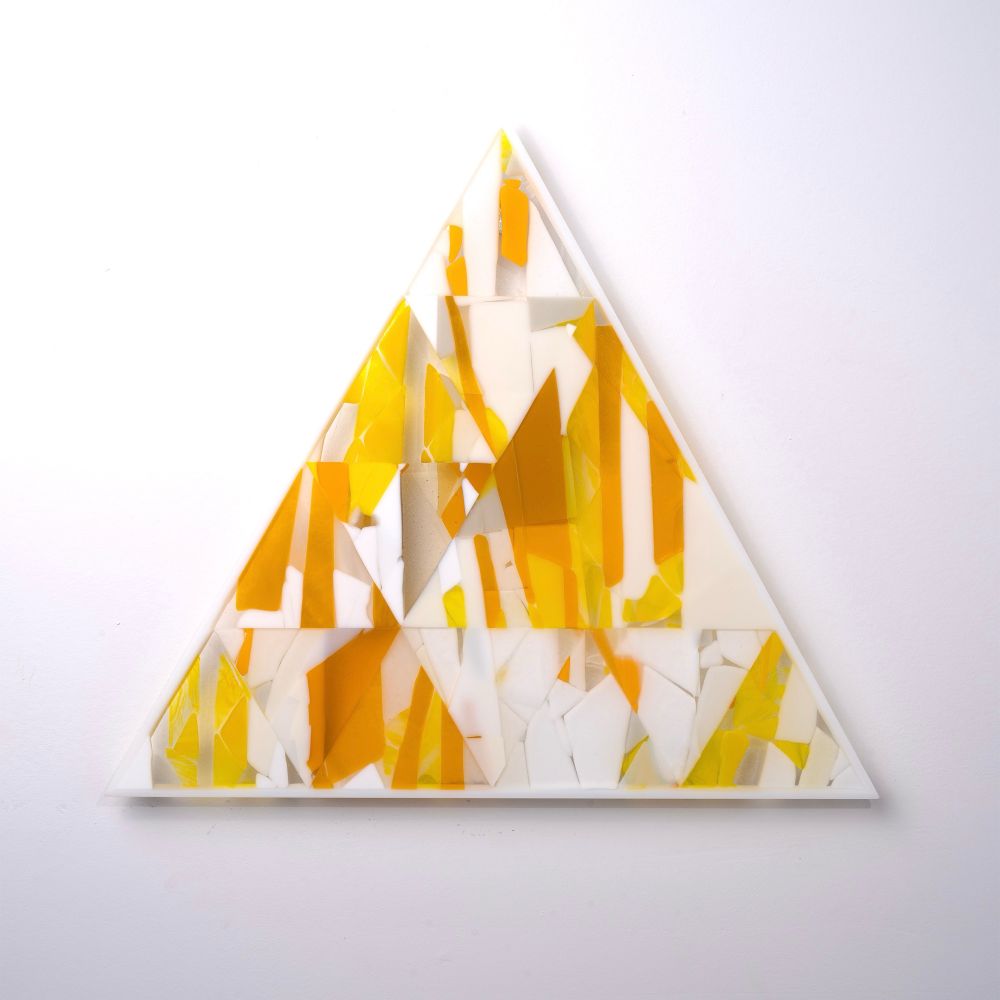 Glass triangle panel made with strips of yellow and white colored glass