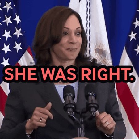 a woman stands in front of a microphone with the words she was right above her