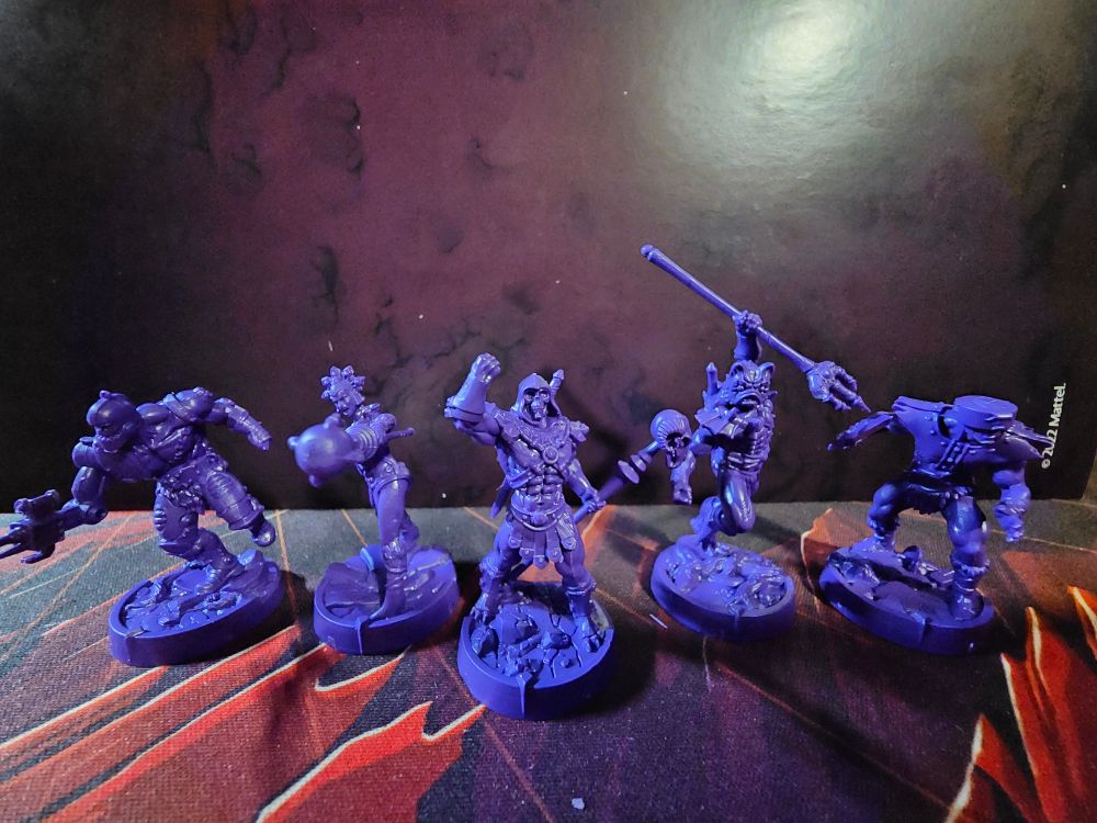 Five Masters of the Universe Battlegrounds miniatures (Trap Jaw, Evil-Lyn, Skeleton, Mer-Man, and Tri-Klops) unpainted and unprimed.