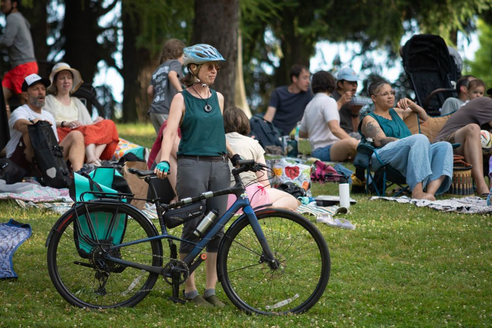 Even attendee watching the show while holding their bicycle