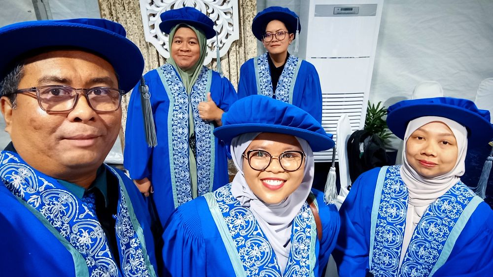 Five humans in blue academia robes 