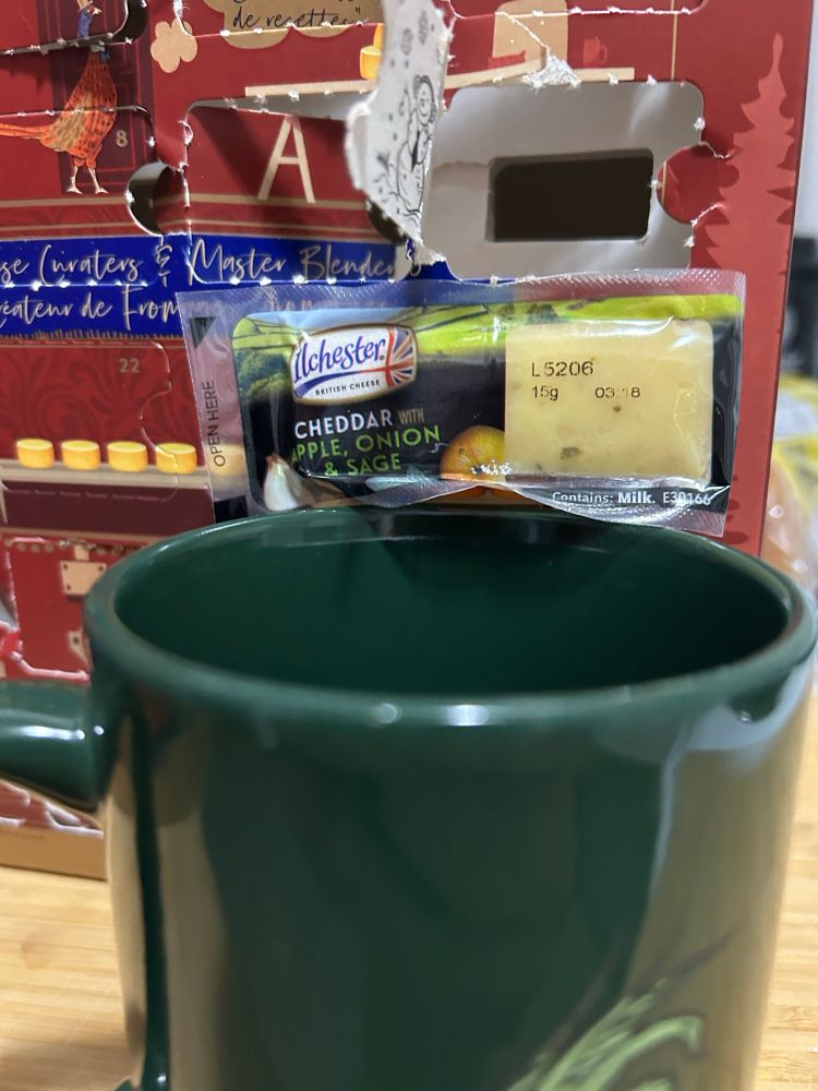  Loss us of wrapped cheese on top of green mug. 