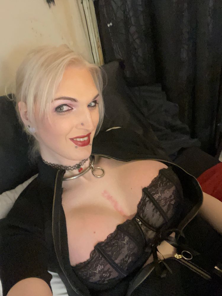 Black lace bra, showing off bust , kind of grinning. 