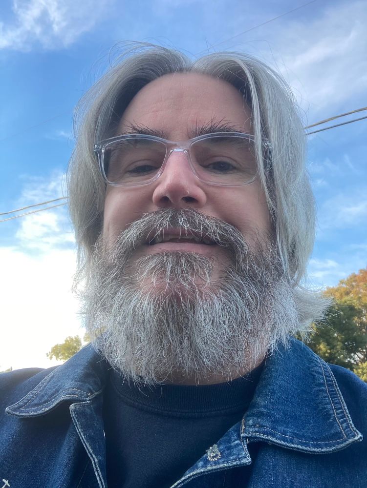 Me at the end of 2020, with long hair and a beard