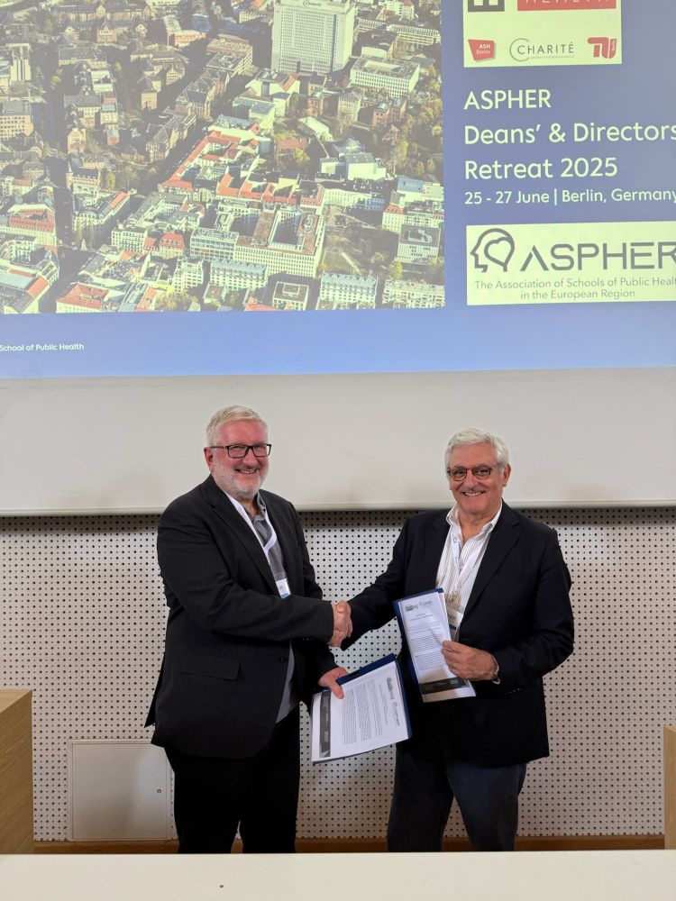 Tit Albreht and Henrique Barros shaking hands to celebrate the signing of the MoU