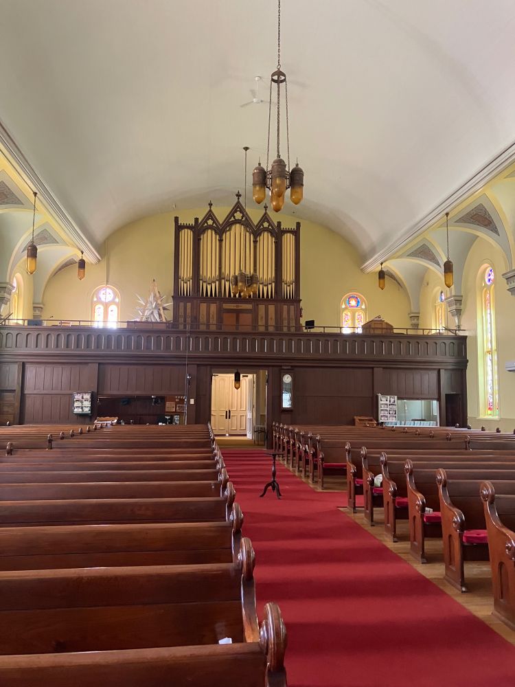 Looking toward the back of the sanctuary toward the choir loft which holds a large pipe organ. 