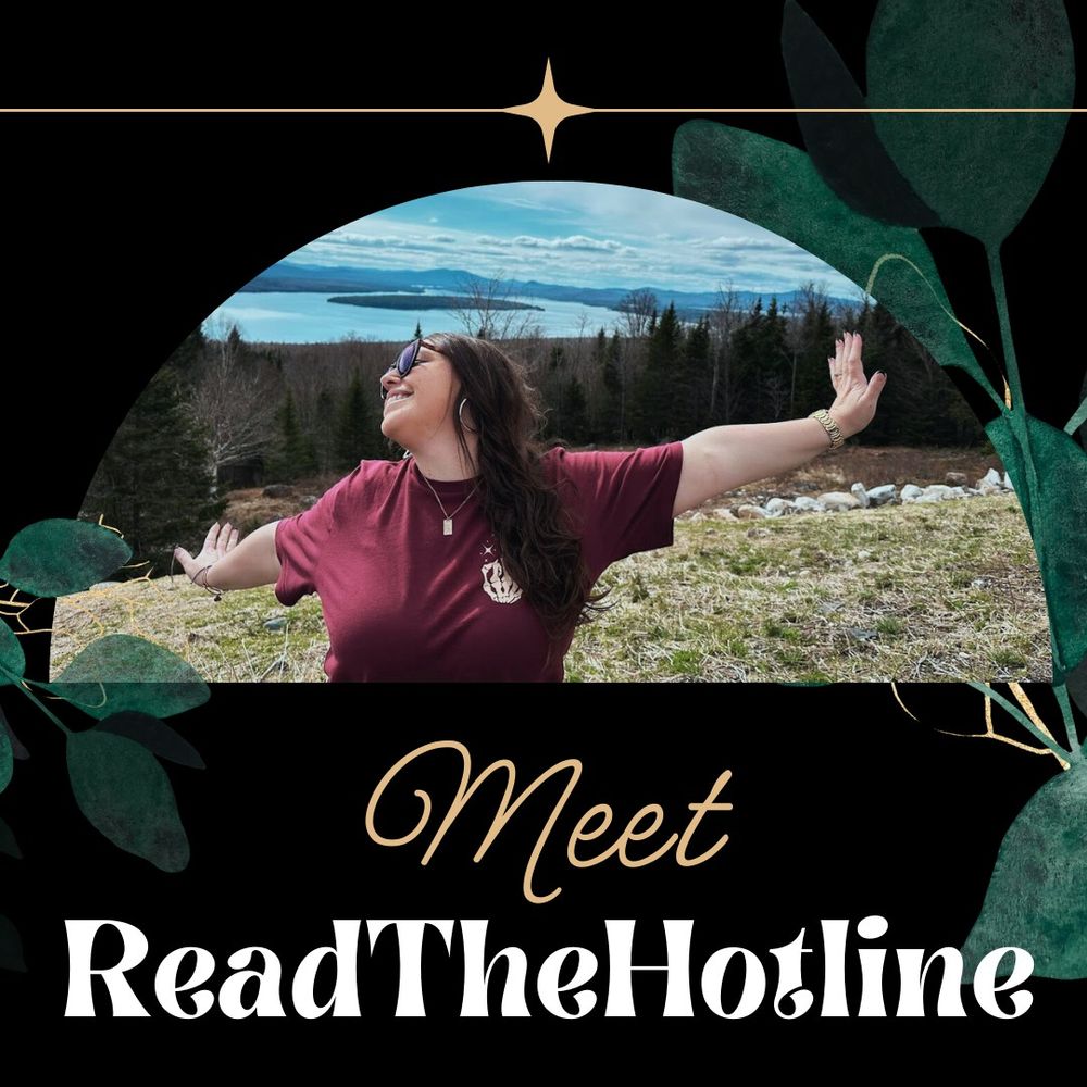 A stylized promotional image with a circular frame showing a joyful person in a burgundy t-shirt with their arms spread wide against a scenic mountain lake backdrop. They're wearing glasses and have long dark hair. The photo is decorated with dark green leaf designs in the corners and a gold star accent at the top. Below the image is elegant text reading 'Meet ReadTheHotline' in contrasting gold script and white serif fonts against a black background.