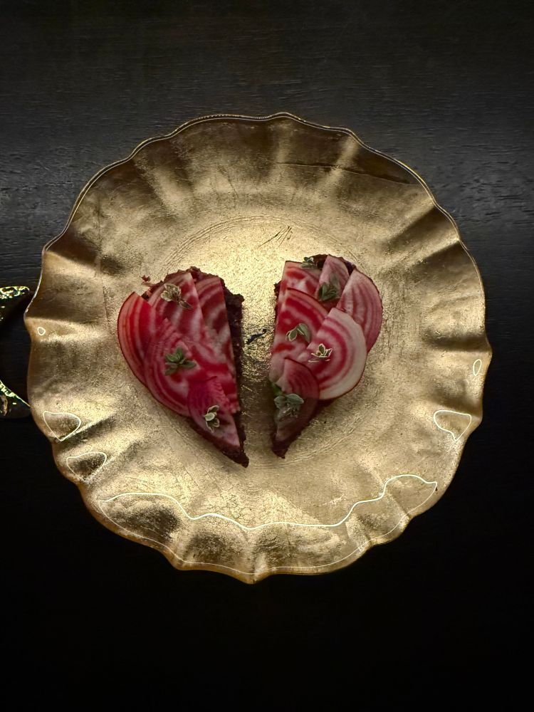 Beet, thyme & almond with a crusty base I forgot what in a heart shape on a gold plate 
