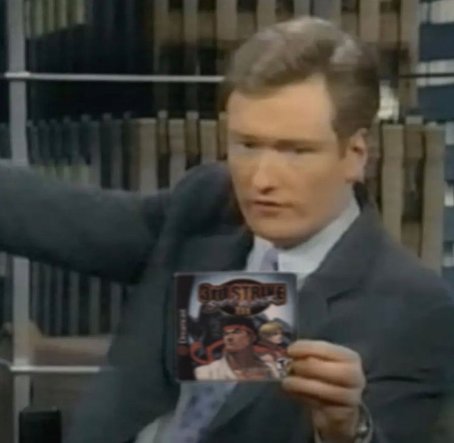 Conan O'Brian displaying a copy of the Sega Dreamcast release of 