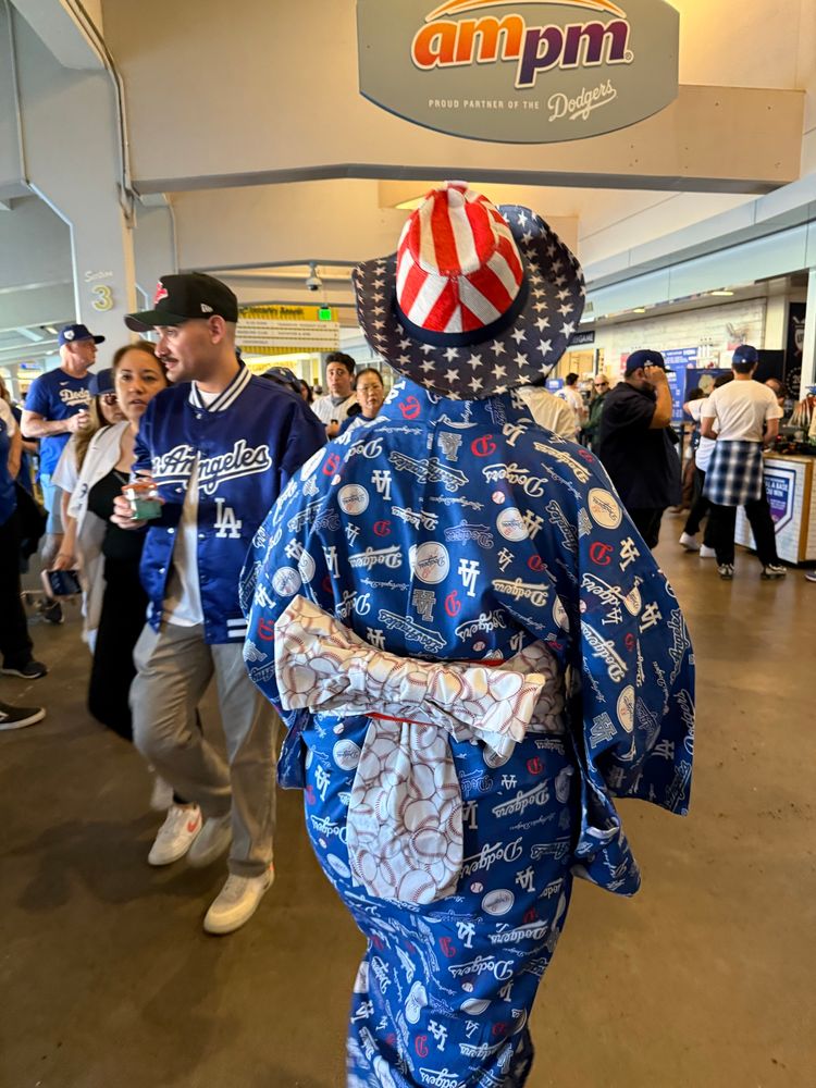 A woman in a blue Dodgers yukata with a white Obi 