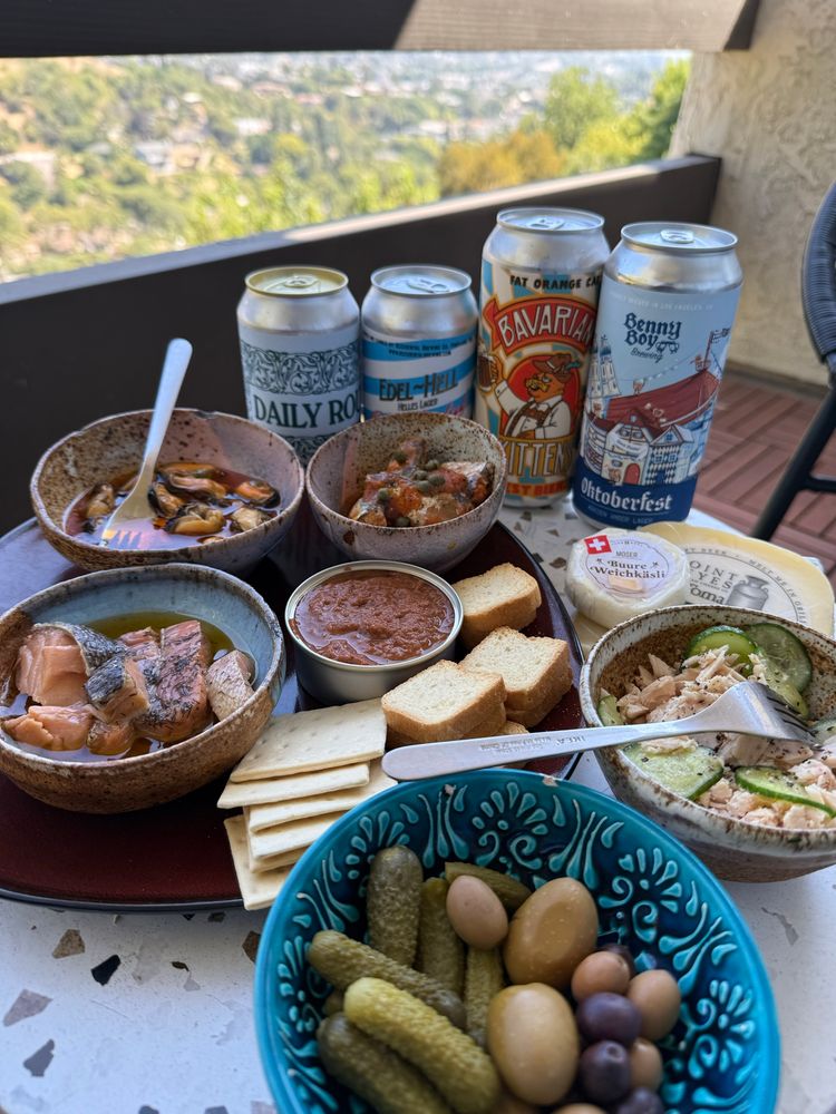 Beers: 
Daily Routine West Coast Pilsner from Homage
Edel-Hel Helles Lager from Occidental
Oktoberfest from a brewery I don’t know 
Oktoberfest from Benny Boy

Fish & stuff:
Clockwise from the top:
Sardine in tomato sauce with capers added

A burre weichkäsli some kinda Swiss soft vhrede
A random Italian artisanal cheese 
Tuna with cucumber
Cornichons and olives
Smoked trout with olive oil and dill
Mussels in olive oil
Octopus pâté and bread and crackers in the center 

We also have tomato slices and maldon salt off picture 
