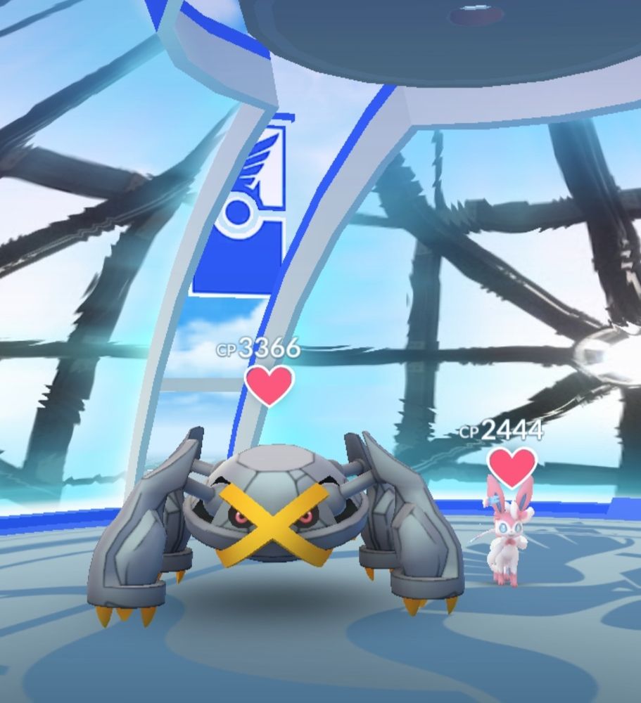 Sylveon (mine) in a pokemon go gym standing next to a shiny metagross