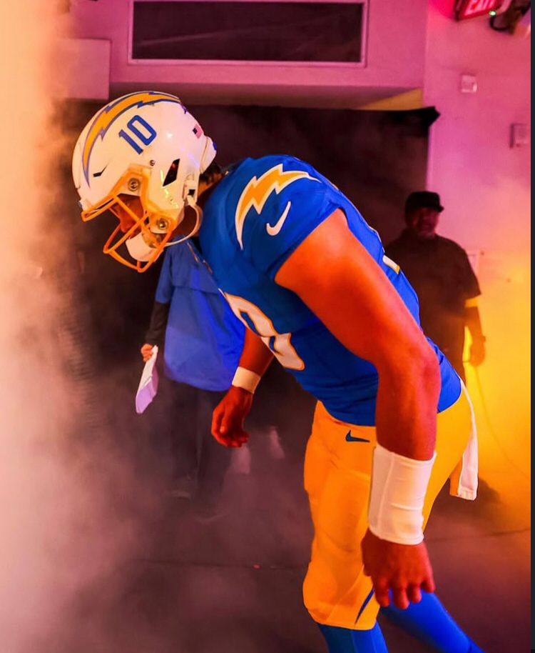 Justin Herbert prepares to take the field with cool smoke and lighting surrounding him.