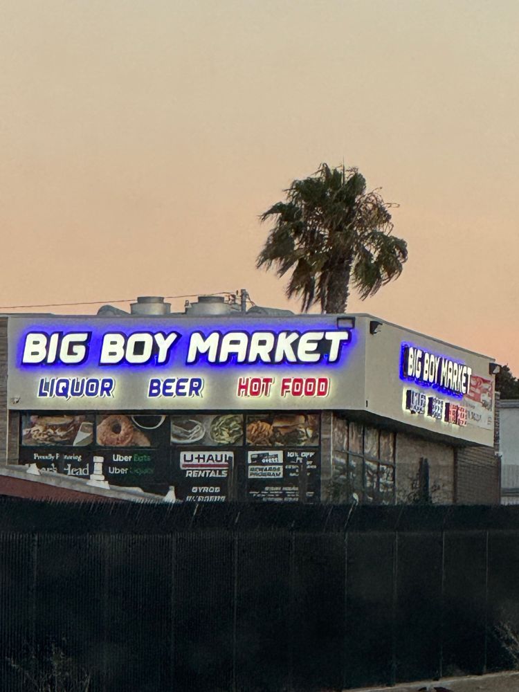 A big storefront with signage that reads “Big Boy Market: Liquor, Beer, Hot Food.”