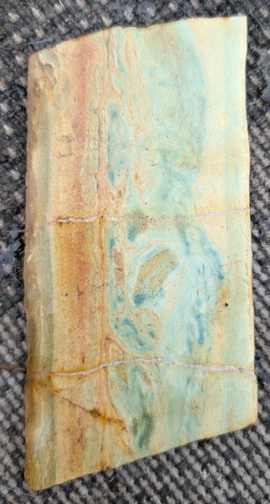 Cream, rust and aqua colored slab