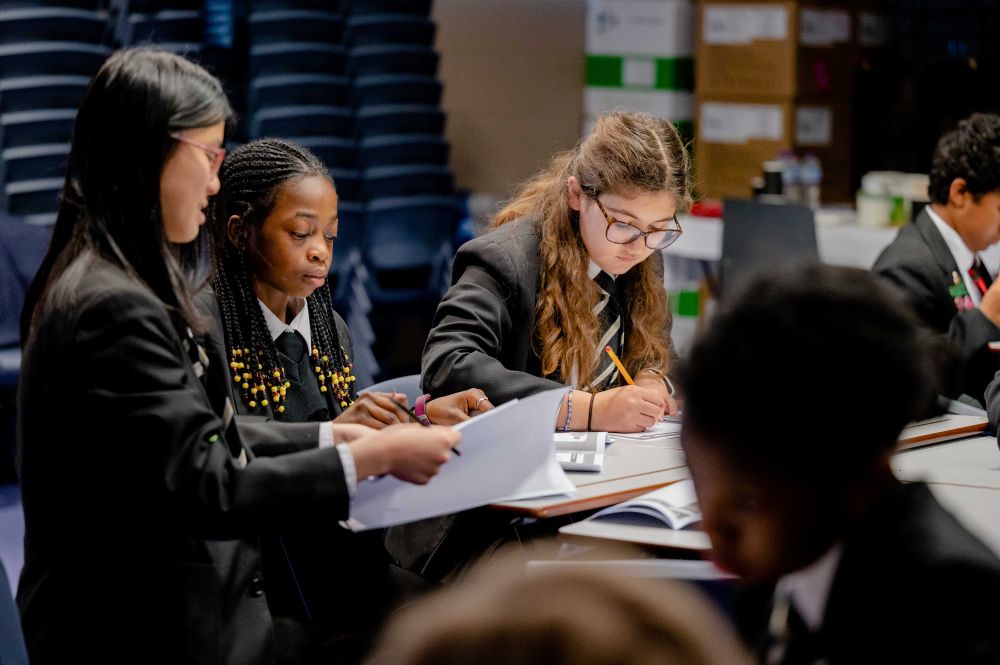 A group of school students studying at desks