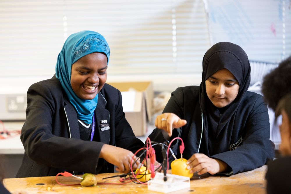 Students in a school science lesson conducting an experiment with fruit
