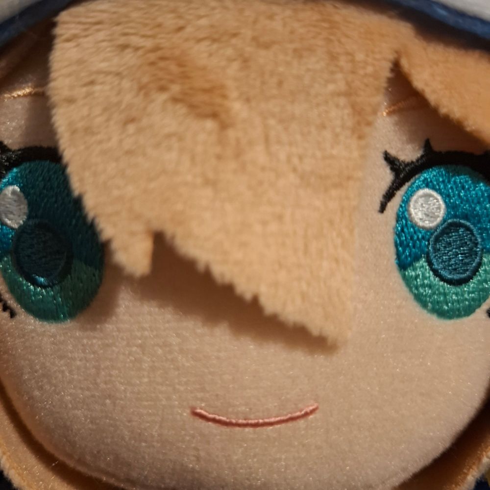 A very close up photo of a Bridget plush face from Guilty Gear Strive 