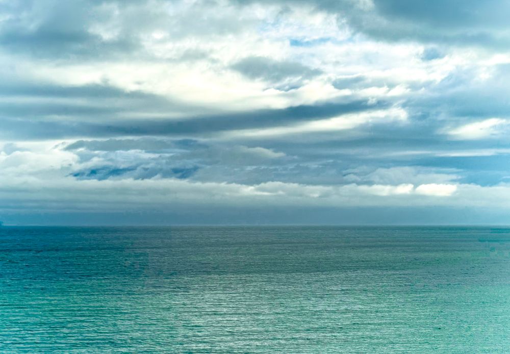 Sea & sky. The sea is green/blue in colour & the sky is overcast with streaky clouds & a bit of brightness