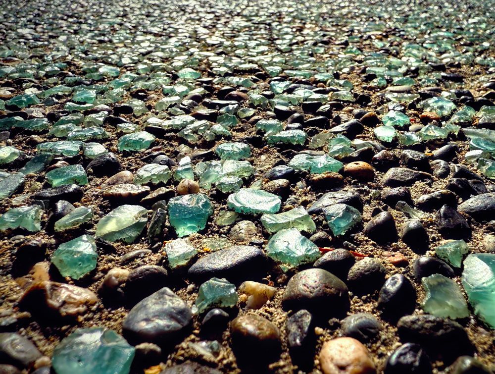 Beach glass & stones paved together as far as the eyes can see.