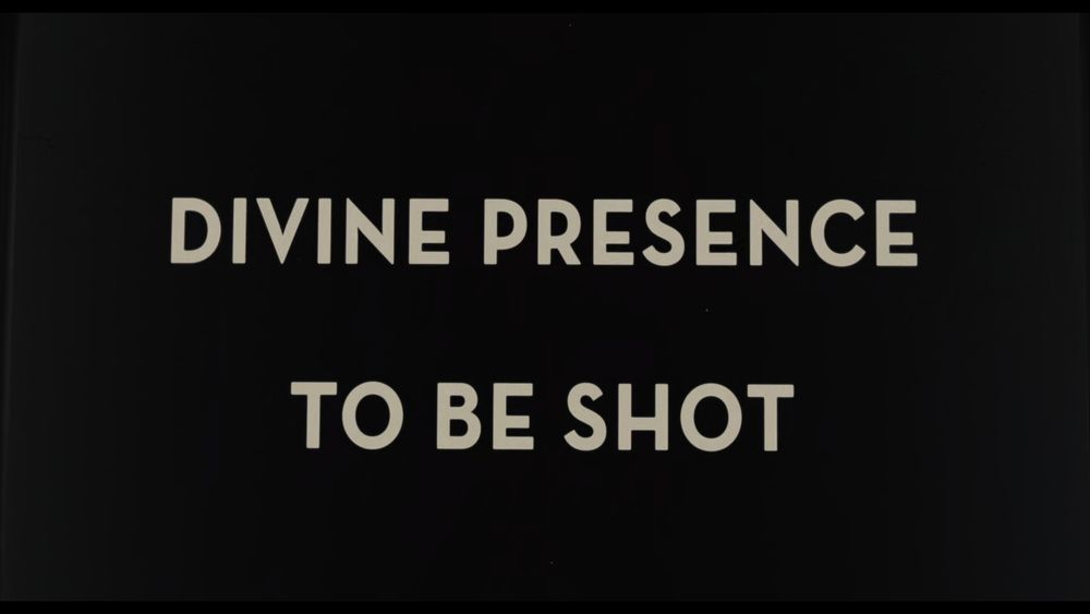 cream text on a black background says DIVINE PRESENCE TO BE SHOT