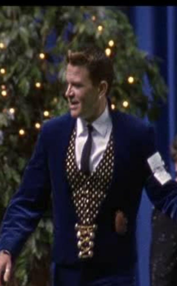 Still shot of John Michael Higgins as Scott showing his dog from the movie Best in Show. 