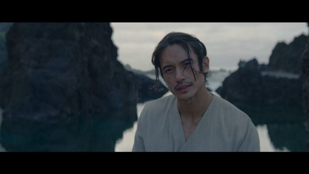 Qimir from The Acolyte staring skeptically.