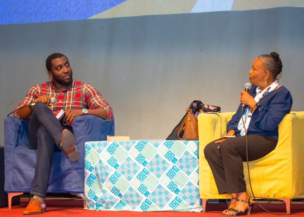 Alain Serge Agnessan and Christiane Taubira on a stage at the Abidjan International Book Fair.