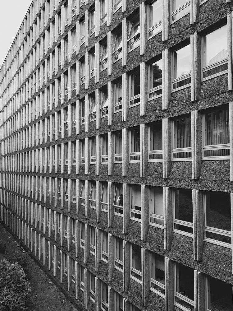 A 1970s (possibly 60s) style office block with small windows going off into the distance 