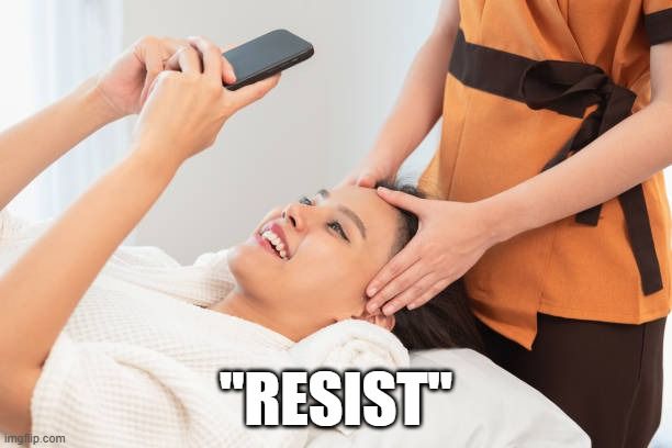 woman on phone getting a massage, typing 