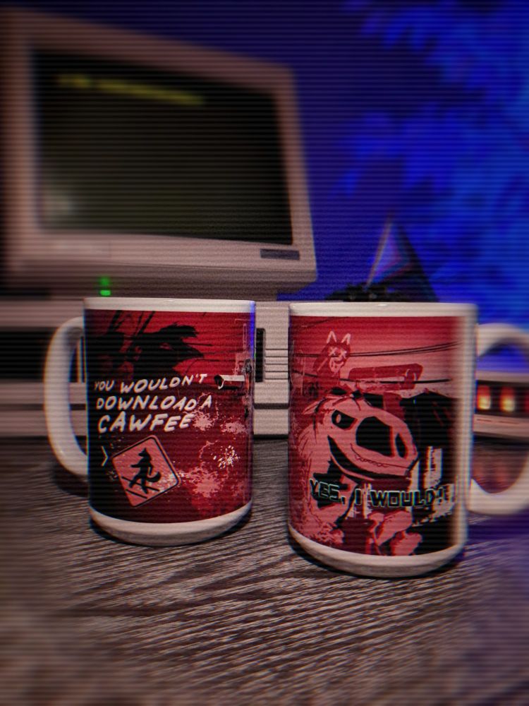 Photo of two Last Caw coffee mugs in front of a retro computer system.