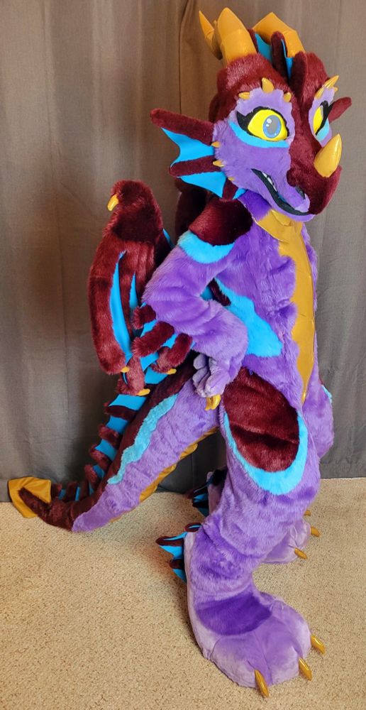 Lovely purple, bronze, and blue dragon with gold accents fursuit