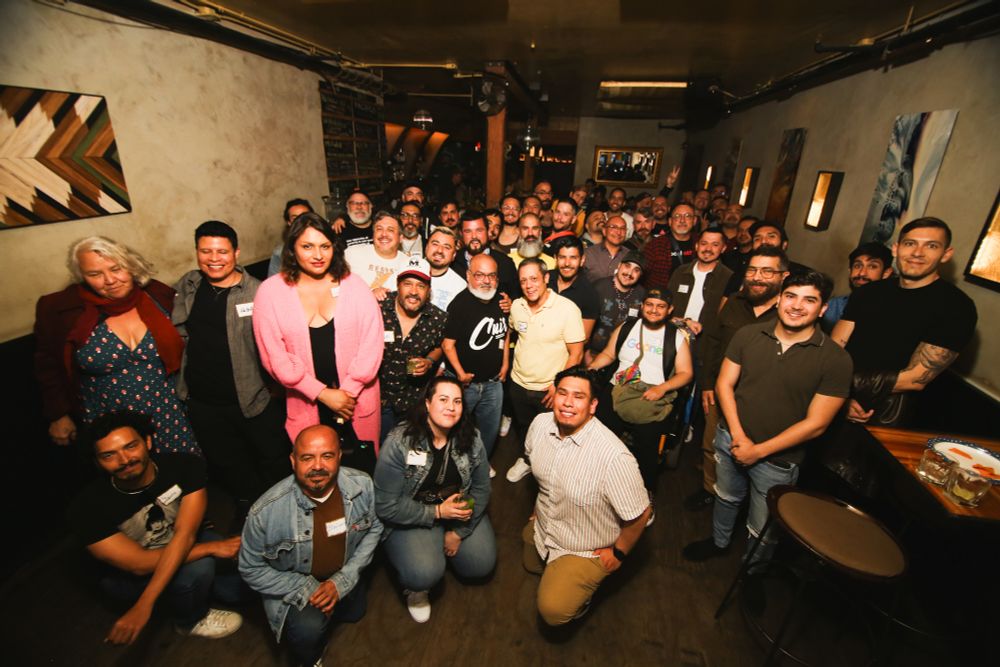 The Queer Latinx Social Club poses for a group photo by Shot in the City Photography.