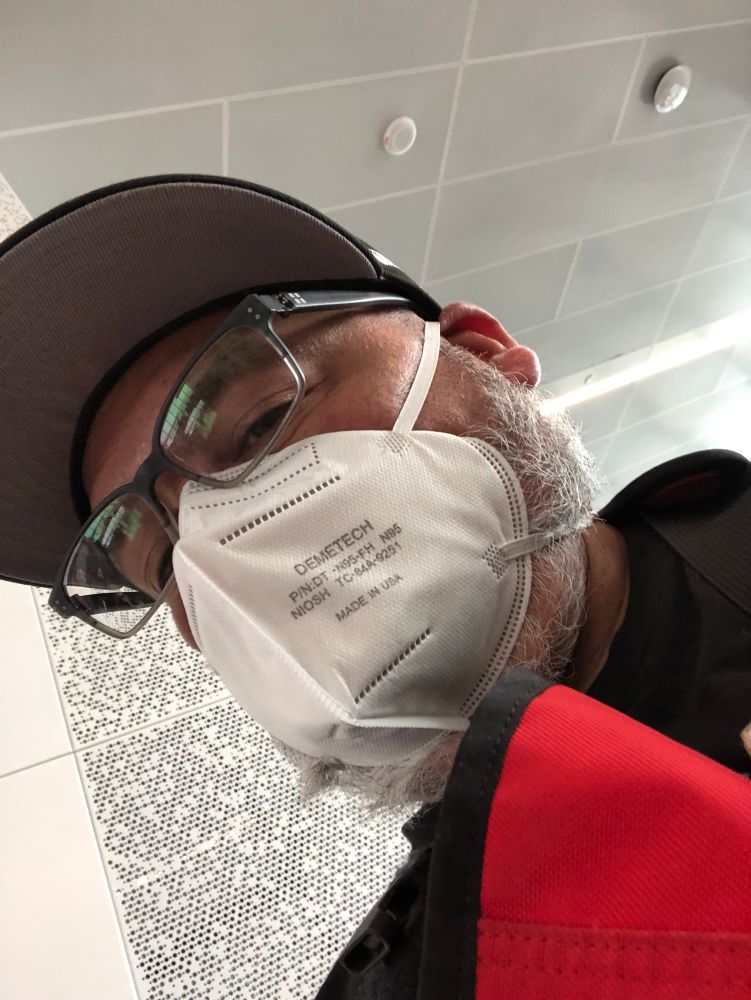 Lito Sandoval in a white N95 mask at San Francisco airport.