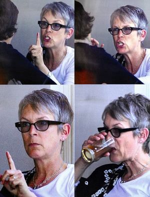 Jamie Lee Curtis having an intense conversation. Pointing and drinking from a glass