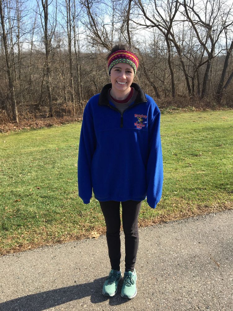 Picture of girl standing in running shoes outdoors