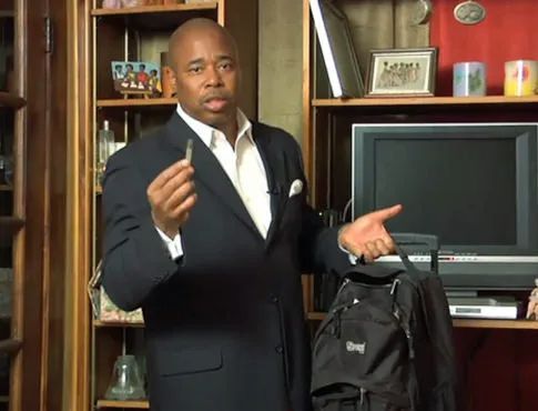 Eric Adams is searching a fake room for fake drugs. Here he found a fake joint in a backpack.