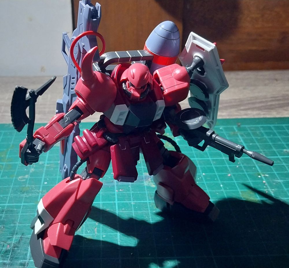 ZAKU Warrior drawing its beam tomahawk and beam assault rifle.