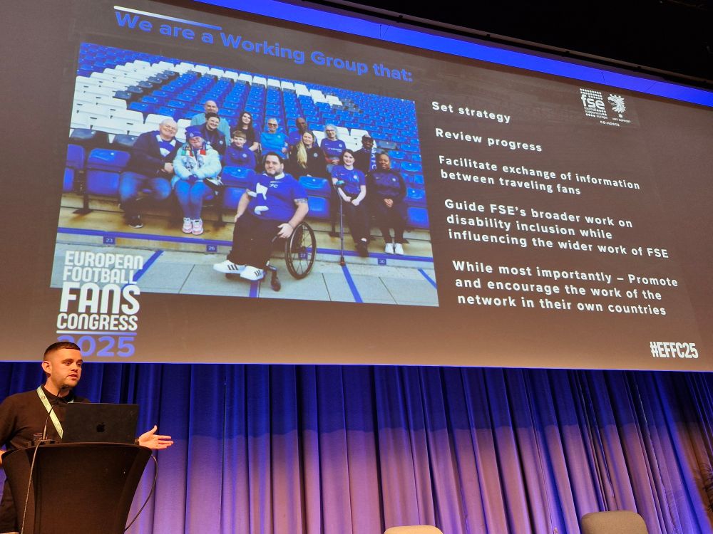 Image description: A big screen with a slide featuring members of the Chelsea DSA. There are details of the FSE's aims for the Diversity and Inclusion Network.