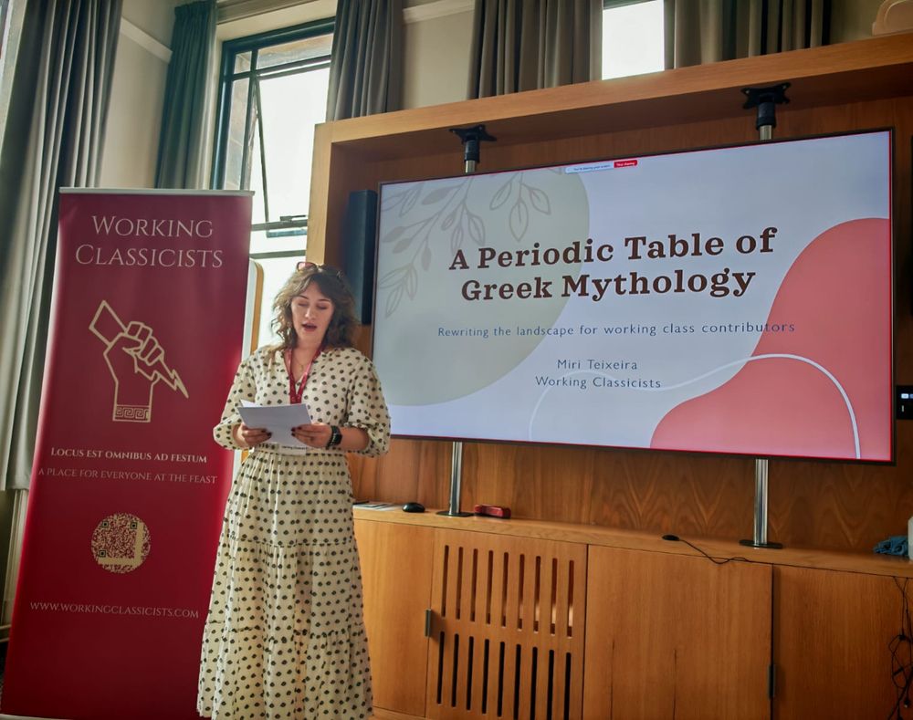 Miri Teixeira from Working Classicists giving a talk on the book A Periodic Table of Greek Mythology at the Classical Association Conference 2025
