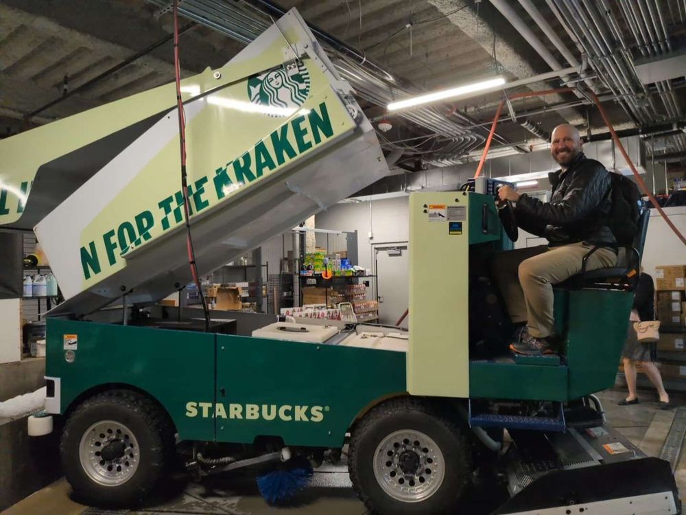 A photo of Kurt Dresner sitting on a Starbucks-sponsored Kraken Zamboni.