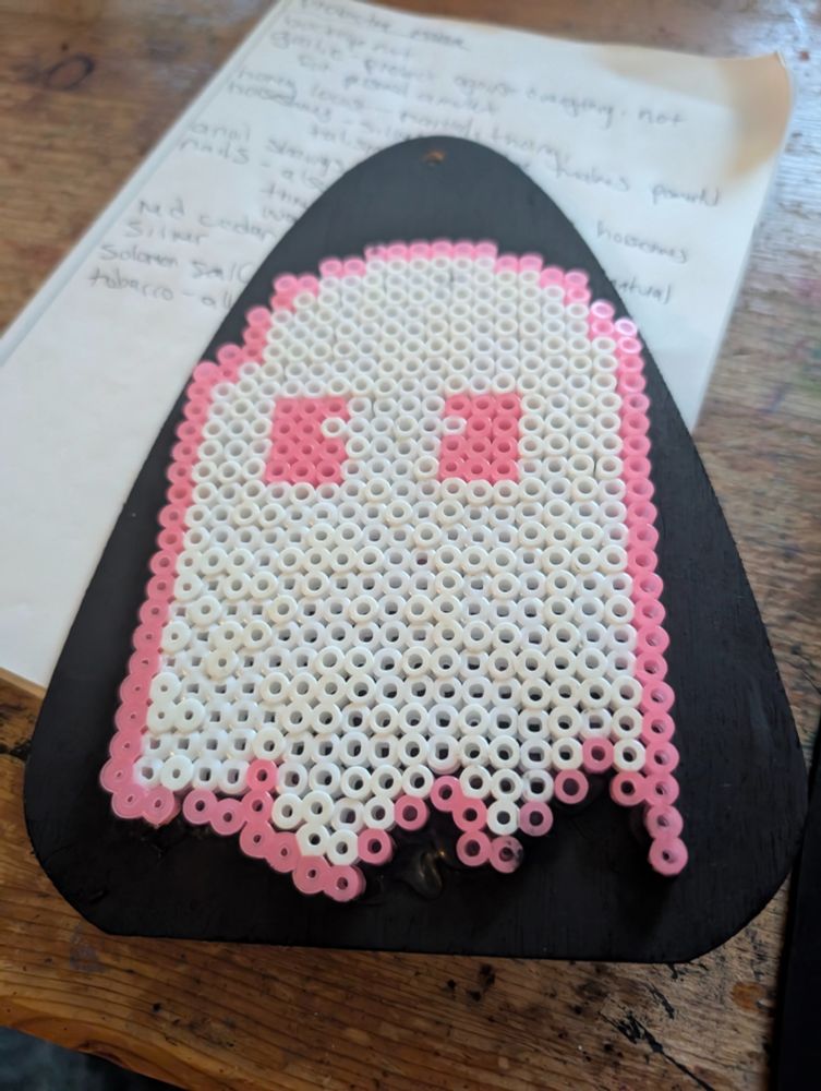 A pink ghostie on a planchet made of plastic melty beads. 