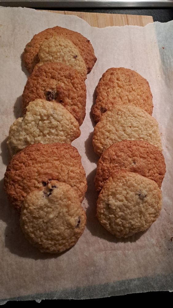 Two lines of cookies on parchment paper 