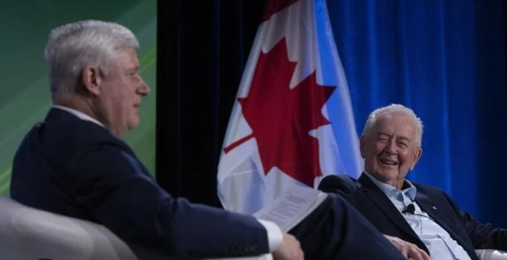 Stephen Harper and Preston Manning sitting together talking