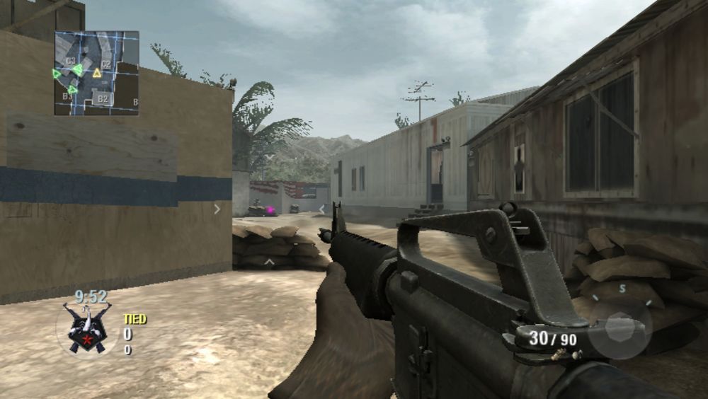 Screenshot of BO1 on the Wii. The scene is a Firing Range. A crosshair pointer is slightly right from the middle of the screen while an assault rifle faces the crosshair, which is close to where a player is standing in the background.